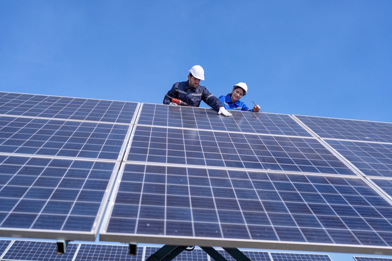 engineers maintaining solar panels
